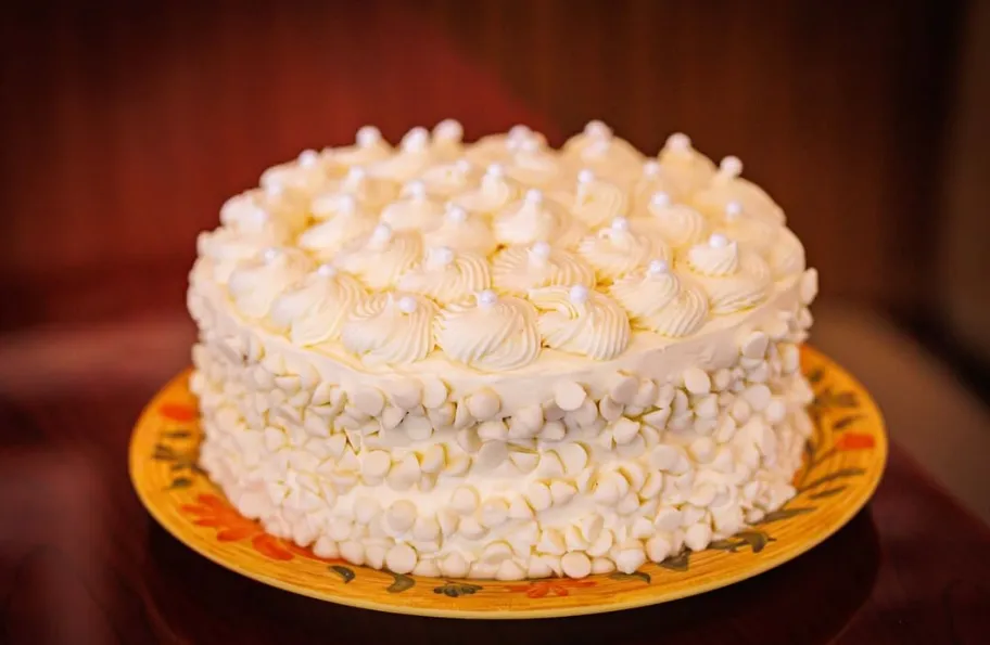 A white chocolate cake piped with rosettes