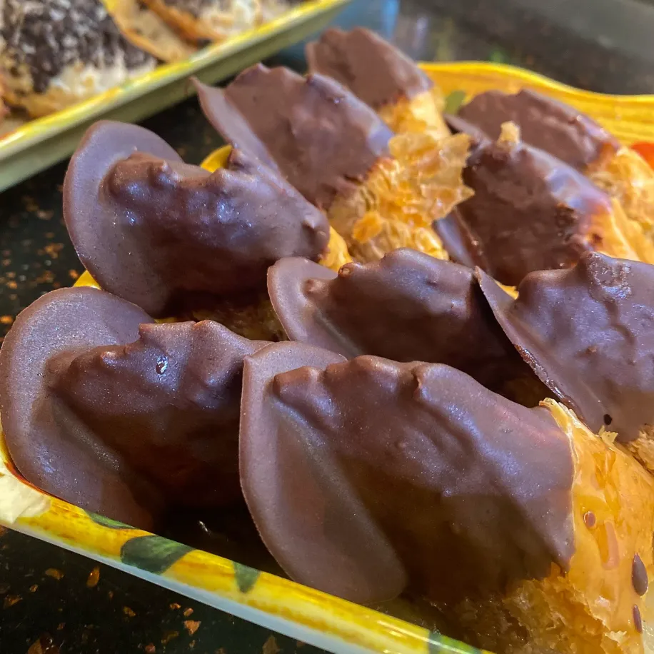 Chocolate dipped baklava pieces on a tray