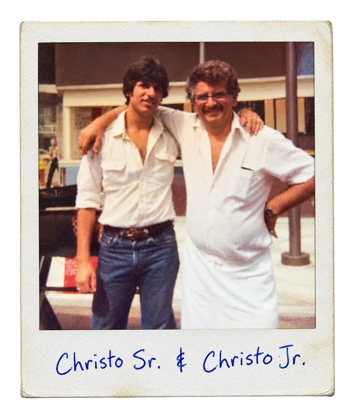 A polaroid of Christo Sr. and Christo Jr. with their arms around each other, captioned Christo Sr. and Christo Jr.