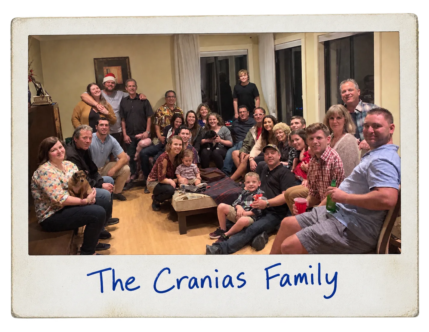 A polaroid of the whole Cranias family gathered in the living room, captioned The Cranias Family