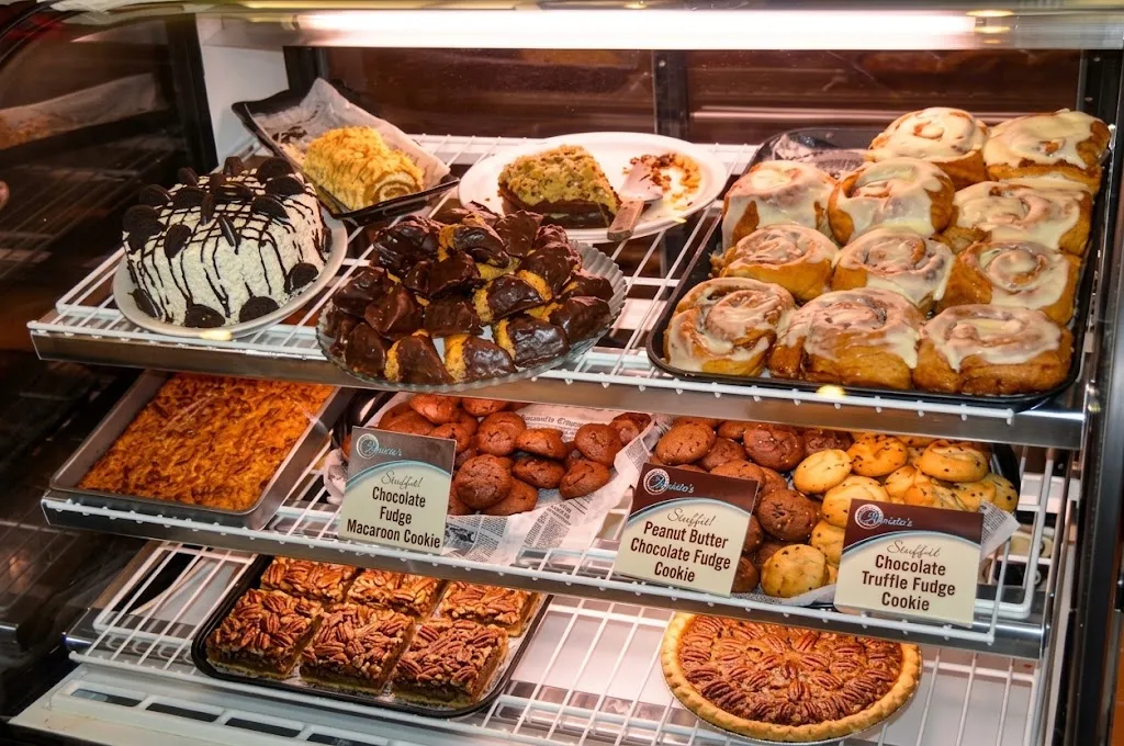 The bakery case stocked with Mrs. Mary's cakes, cookies, baklava and sweet rolls