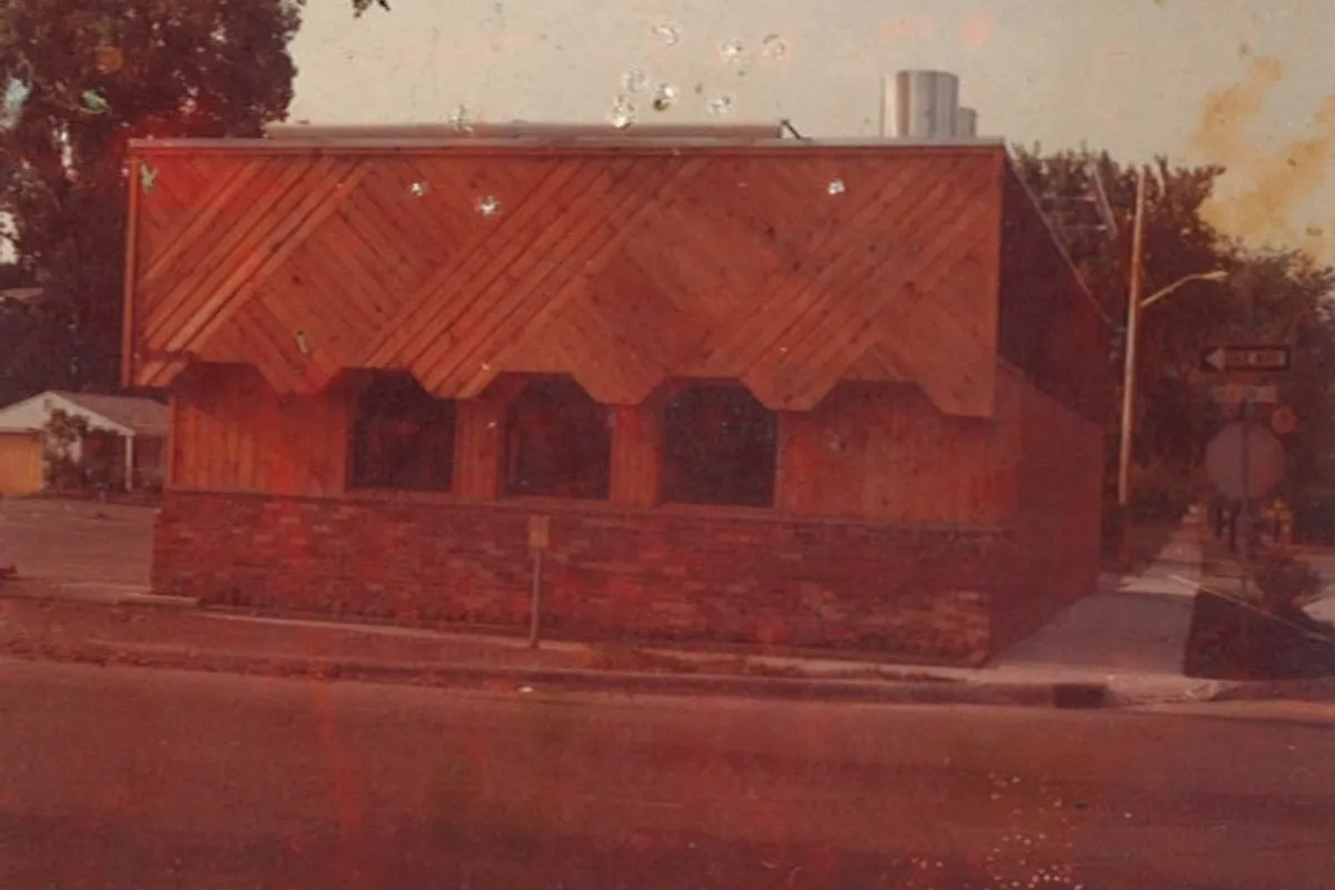 The second Detroit restaurant on 8 Mile Road, wood chevron siding over a brick base