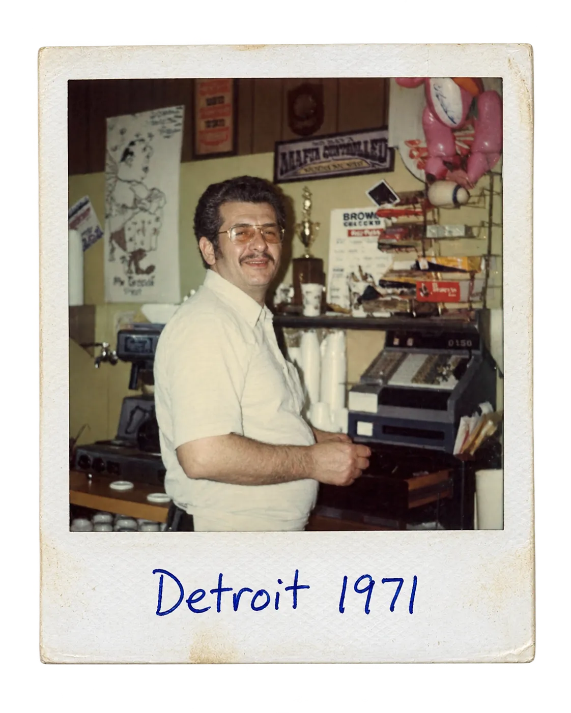 A polaroid of Chris Cranias behind the register of the first restaurant, captioned Detroit 1971